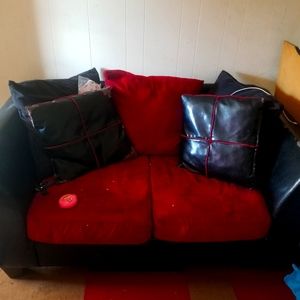 Red and black living room set few torns.